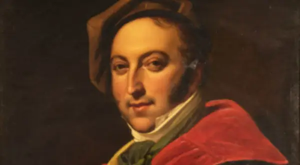 Portret Gioacchino Rossiniego w czerwonej todze i brązowym kapeluszu.